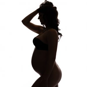 Pregnant woman practicing prenatal pilates
