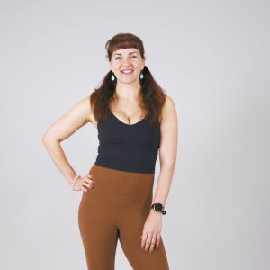 Instructor guiding alignment-focused pilates movements